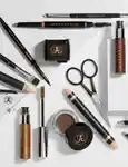 An assortment of Anastasia Beverly Hills brow products scattered on a table