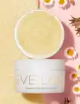 Open Eve Lom cleanser surrounded by daisies