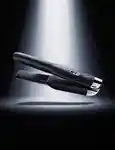 Ghd unplugged straightener floating with a light beam shining on it