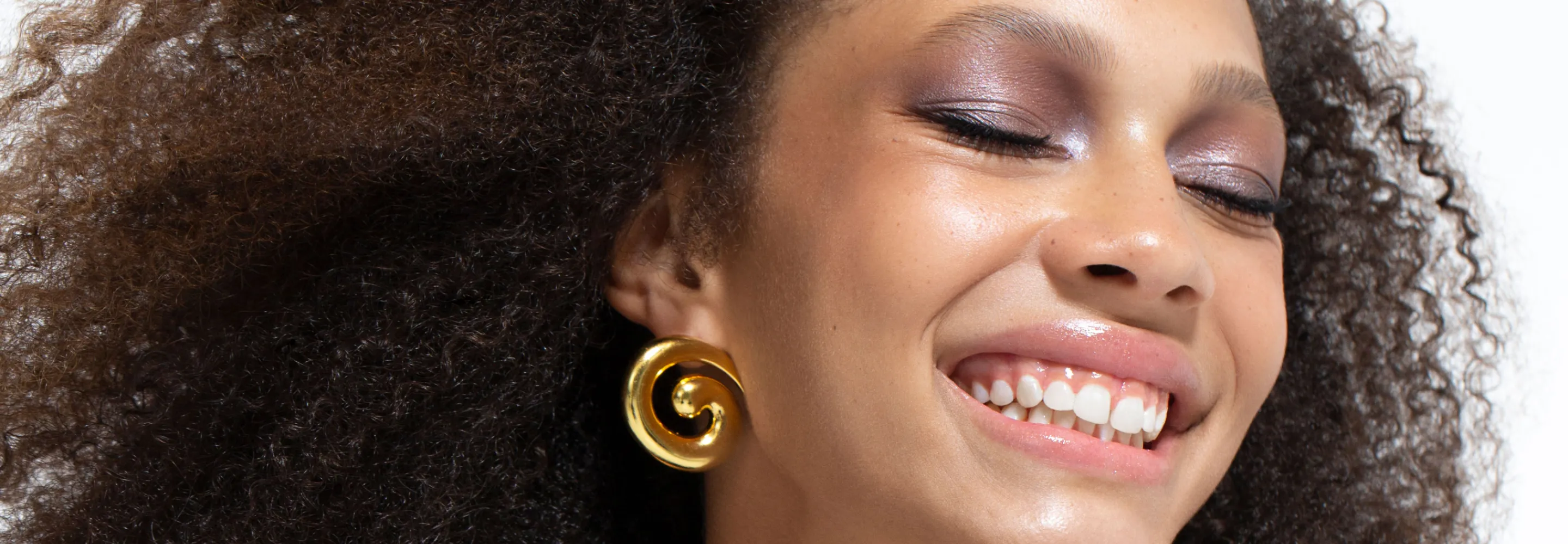 laughing model with curly hair