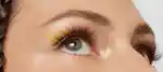 closeup of a model's eye with false eyelashes and yellow eye makeup