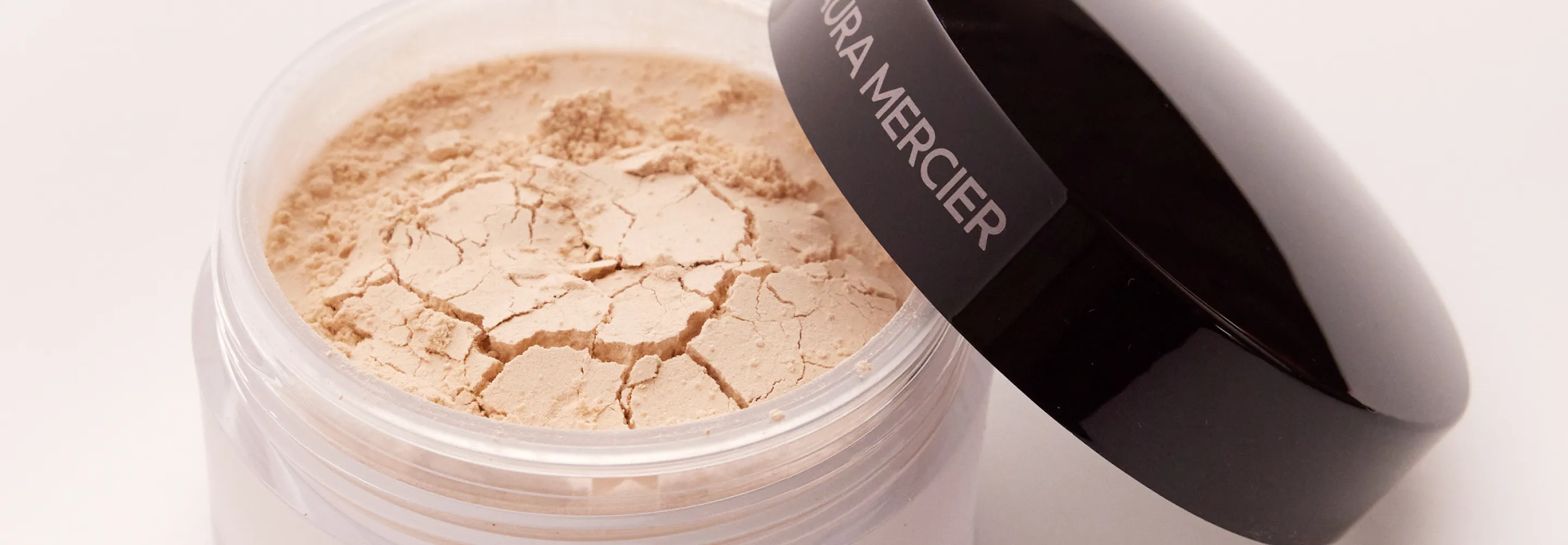 an open jar of laura mercier translucent loose setting powder