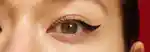 closeup of a model's eye with black winged eyeliner