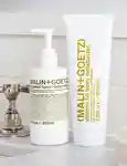 Malin+Goetz Vitamin B5 body moisturiser and bergamot hand + body wash side by side on a sink