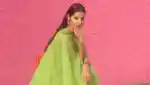 Baba Rivera Founder Of Ceremonia on pink background with green dress