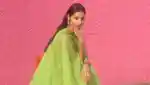 Baba Rivera Founder Of Ceremonia on pink background with green dress