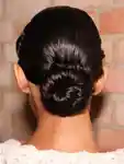 The back of a model's hair backstage with a bun