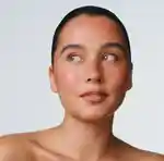 A face with a light, sunkissed flush