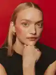 Portrait of a blonde female model, wearing berry coloured blush and lipstick.