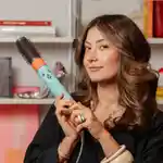 Model holding Dyson Airwrap styler