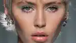 Model with blue pastel eye look walking the runway at Versace