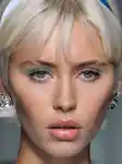Model with blue pastel eye look walking the runway at Versace