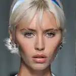 Model with blue pastel eye look walking the runway at Versace