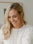 Portrait of Pure Mama Founder Lara Henderson; a blonde woman smiling.