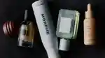 Flat lay of a range of beauty products on a black background