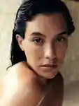 Model with wet hair looking at the camera.