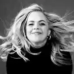 Black and white portrait of Taryn Brumfitt.