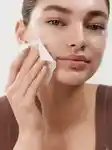 close up of girl wiping her face with a cloth