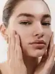 close up of girl touching her face and looking at the camera
