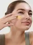 Model applying skincare treatment